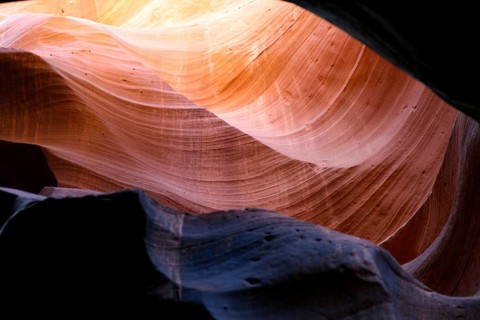 Beam of light on a colourful rock face
