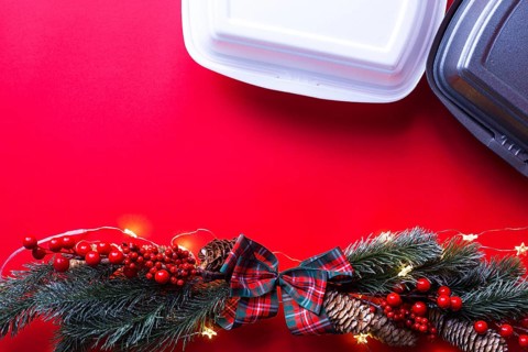 Christmas decor of food delivery service containers. New year's eve promotion. Ready-made hot