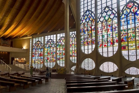 Rouen, France, August 30, 2018: Old Renaissance stained glass windows in a modern catholic church