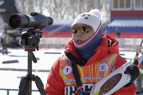 Coach of South Korea biathlon team instructs biathletes at shooting range of biathlon stadium