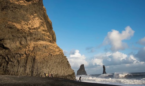 Unrecognised people sightseeing at reynisfjara black sand beach in Vik I mydral south Iceland.