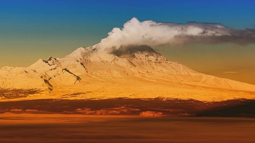 Eruption crater active volcano on Kamchatka Peninsula, winter volcano landscape at sunrise.