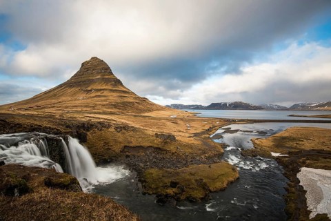 The Kirkjufell mountain and the kirkjufellfoss waterfall at grundarfjordur at Snaefellsnes