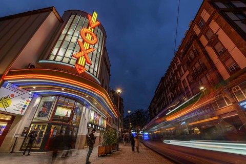 The Vox cinema in Strasbourg illuminated at night. Bas-Rhin, Alsace, Grand Est, France, Europe