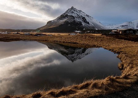Mountain landscape at and hilltop reflection at a lake. Arnarstapi area in Snaefellsnes peninsula
