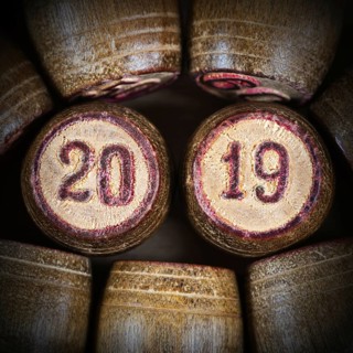 Wooden vintage lotto kegs with two numbers 20 and 19 as symbol of 2019 year. Close-up top view of