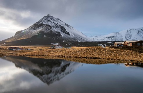 Mountain landscape at and hilltop reflection at a lake. Arnarstapi area in Snaefellsnes peninsula