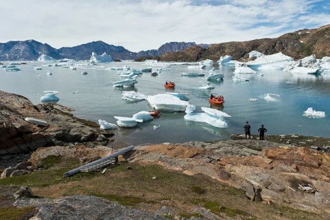 Motorboats on their way through icebergs to the Austrian polar station or polar research station
