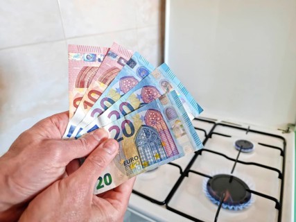 Energy efficiency concept with gas cooker and euro currency – the cost of natural gas is more
