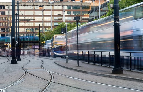 Manchester, England, September 23, 2016: Piccadilly central bus and metro station with moving tram