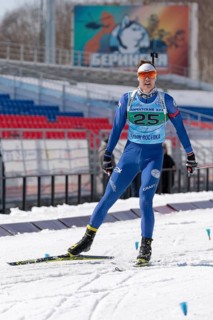 Kamchatka sportsman biathlete Ageev Danil in action skiing on ski track distance biathlon arena.
