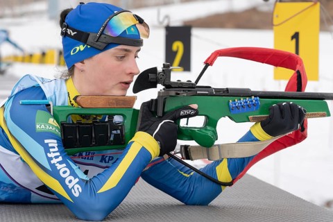 Biathlete Kryukova Arina Republic of Kazakhstan rifle shooting in prone position. Biathlete in