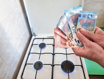 Energy efficiency concept with gas cooker and euro currency – the cost of natural gas is more