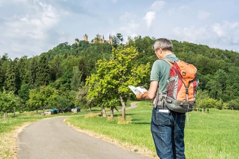 Male hiker looking at his hiking guidebook