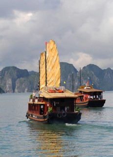 Halong Bay, Vietnam, August 5 2010: Tourist boat sailing on the famous Halong bay transferring