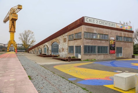 Yellow crane and dry dock, former shipyard of the Chantiers d'Atlantique on the Ile de Nantes in