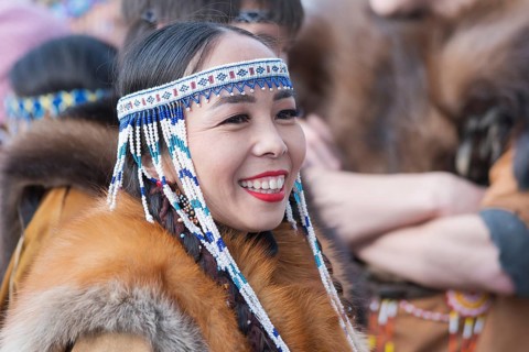 Portrait smiling expression female in traditional clothing aborigine people Kamchatka Peninsula.