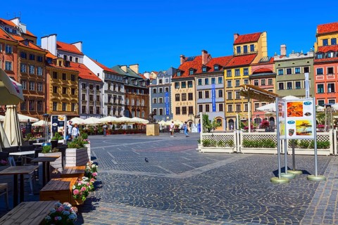 Warsaw, Poland, June 24, 2019: Mermaid of Warsaw, Syrenka Warszawska, colorful houses in Market