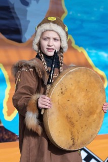 Girl dancing with tambourine in tradition clothing aboriginal people Kamchatka Peninsula. Concert,