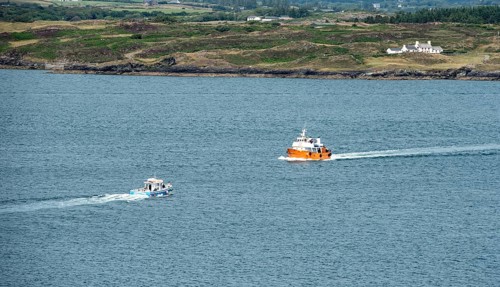 Small fishing boat sailing in Atlantic sea. Leisure activity, for whale watching, sport and