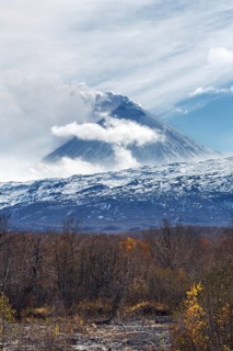 Volcanic landscape of Kamchatka: active Klyuchevskaya Sopka, view of volcanic eruption, plume of