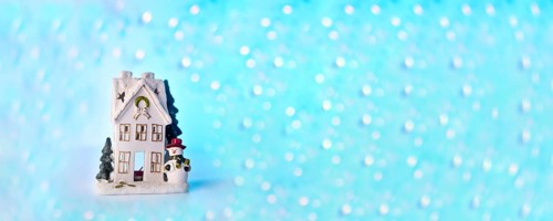 Christmas or New Year snow house decoration, snowman, blue bokeh background with lights banner