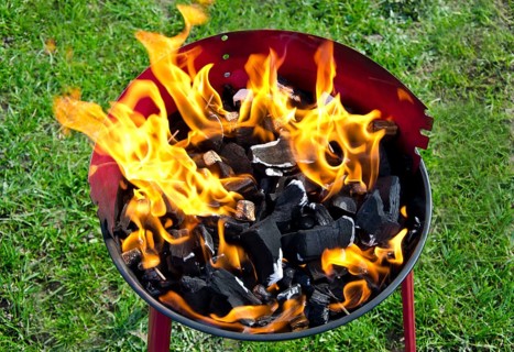 Flames and coal on a barbecue grill in summer