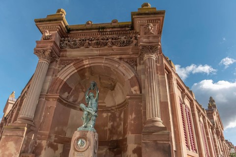The statue of the winegrower, work of Auguste Bartholdi in front of the covered market in the city