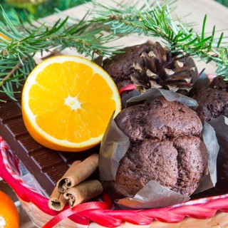 Christmas holiday still life with close up muffins, cinnamon sticks, oranges, chocolate and pine