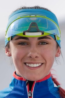 Portrait of smiling sportswoman biathlete Polina Yegorova Kazakhstan at finish after rifle shooting