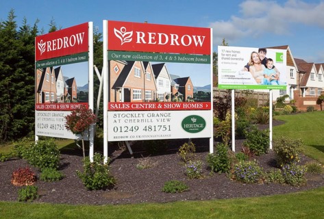 Redrow advertising poster signs for new housing for sale at Cherhill View, Stockley Grange, near