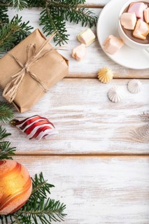 Christmas or New Year frame composition. Decorations, box, balls, cinnamon, ribbons, fir and spruce