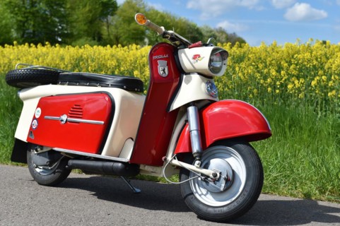 Vintage scooter, motorbike Troll 1 in spring in front of a rape field