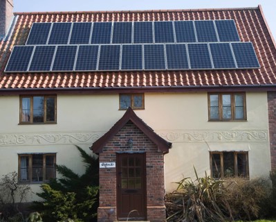 Solar panels on roof of old cottage, Yoxford, Suffolk, England, United Kingdom, Europe