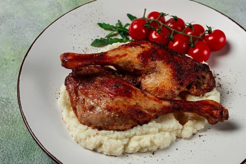 Fried duck shank, cauliflower puree, cherry tomatoes, homemade, no people