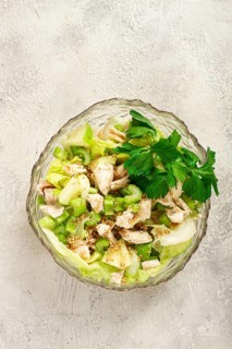 Waldorf salad, celery salad with apple, in a glass salad bowl, natural light, homemade, no people