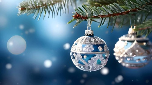 Set of Christmas ornaments hanging on a snow-covered pine tree branch, with frost clinging to the
