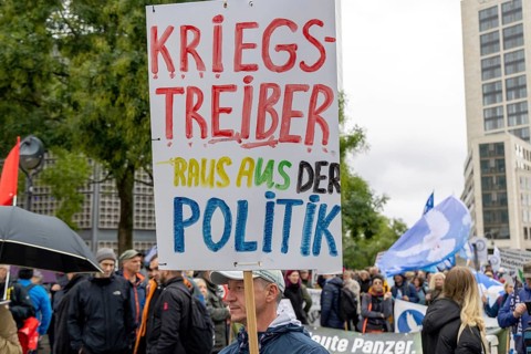 War-mongers out of politics poster at the Lay down your arms demonstration at Breitscheidplatz in