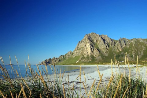 Island in the sea with calm sandy beach and blue sky with clouds, Bleik, Vesteralen, Langoya,