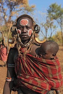 South Ethiopia, in Maco National Park, Mursi tribe, Mursi woman with baby, painted skin and