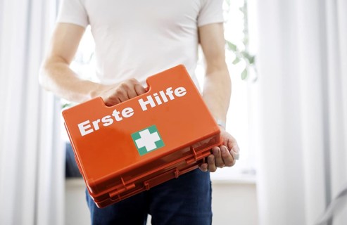 Occupational safety. A man holds a first aid kit in an office in Berlin, 09/08/2024