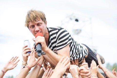 Beat Schmutz, singer of the band Schmutzki crowdsurfing on the beach in front of the Becks Beach