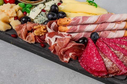 Appetizer, assortment, set, sausage, and cheese, on a wooden board, top view, no people