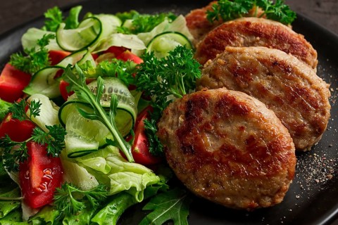 Fried cutlets, turkey, with vegetable salad, top view, no people