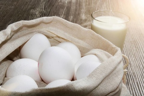 Symbolic image of baking ingredients: Eggs in a cloth bag