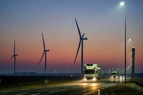 Lorry on the road to Euromax Terminal Rotterdam, ENECO wind farm on the dike around the port of
