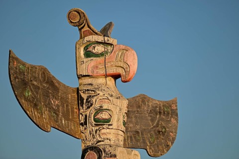 Kwakwakawakw totem pole at the cemetery in Alert Bay, Cormorant Island, British Columba, Canada,