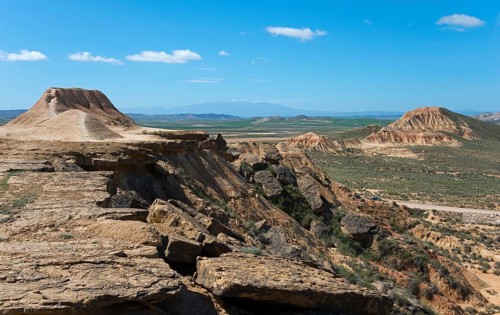 Vast landscape with a plateau and hills under a clear blue sky, Bardenas Reales Natural Park,