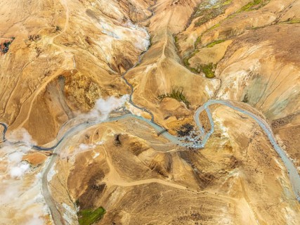 Steaming hot springs and colourful rhyolite mountains, aerial view, Hveradalir geothermal area,