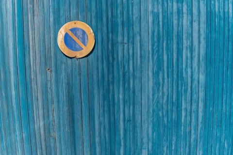 Garage door boards stained blue with worn paint. Brittany France